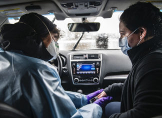COVID Diaries Colorado: A Day in the Pandemic Nurse Practitioner Lisa Robbiano, left, talks to Fabiola Grajales, 27, while checking her lungs and heart rate in Robbiano’s car next to the MIRA COVID-19 testing bus in El Jebel on Thursday, April 16, 2020. This was Grajales’s fourth COVID-19 test. She was confirmed positive during the three prior tests and was positive for pneumonia. She first got sick on March 2nd with flu-like symptoms and had been on three different antibiotics since. “I can’t imagine how it is for people who don’t have insurance, who don’t speak the language, and who don’t have any knowledge of how the medical system works,” said Grajales about her experience with COVID-19 testing.